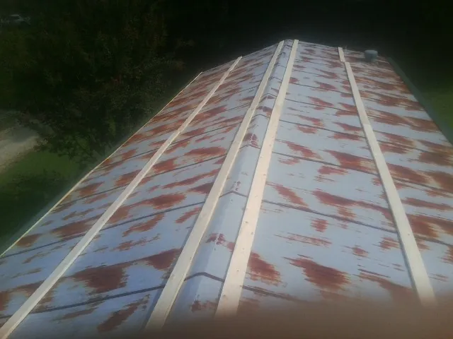Rusted metal roof panels with new wood purlins before replacement — Storm Damage Roof Repair in Gibsonia by Roofing Brothers