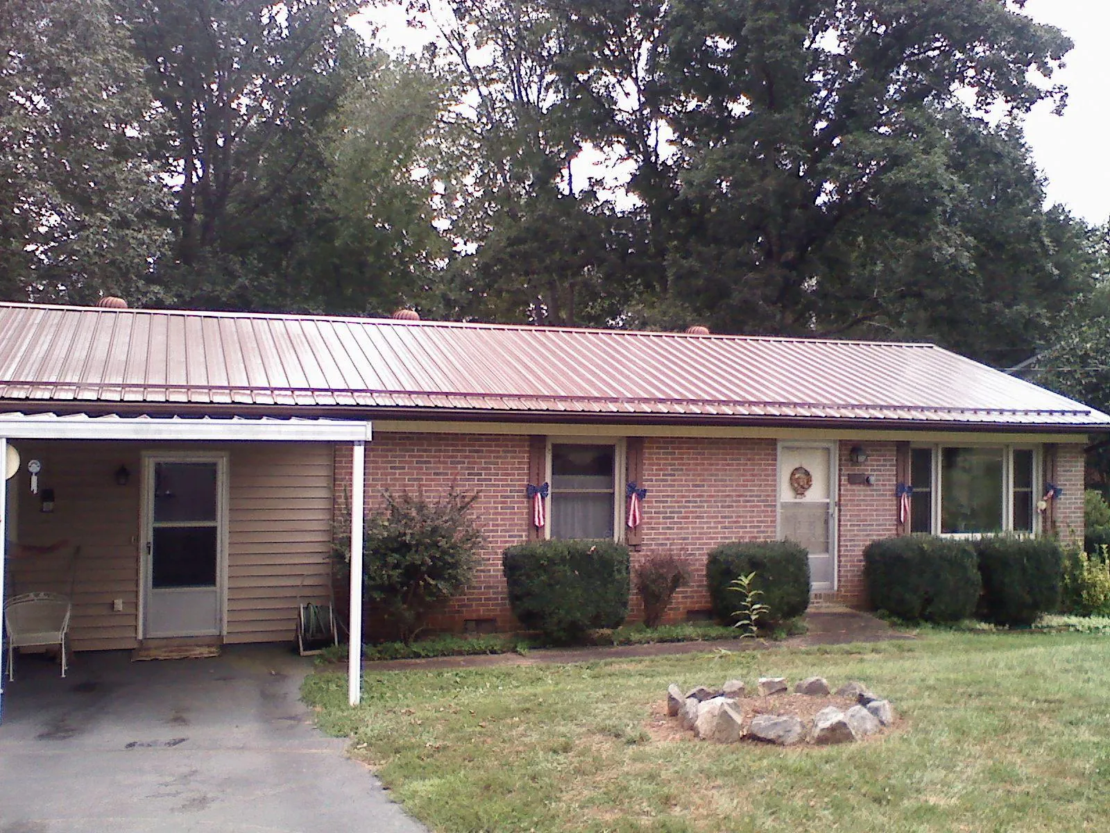 Bronze metal roof and carport on a brick ranch home — Roof Repair work by our crew in Gibsonia