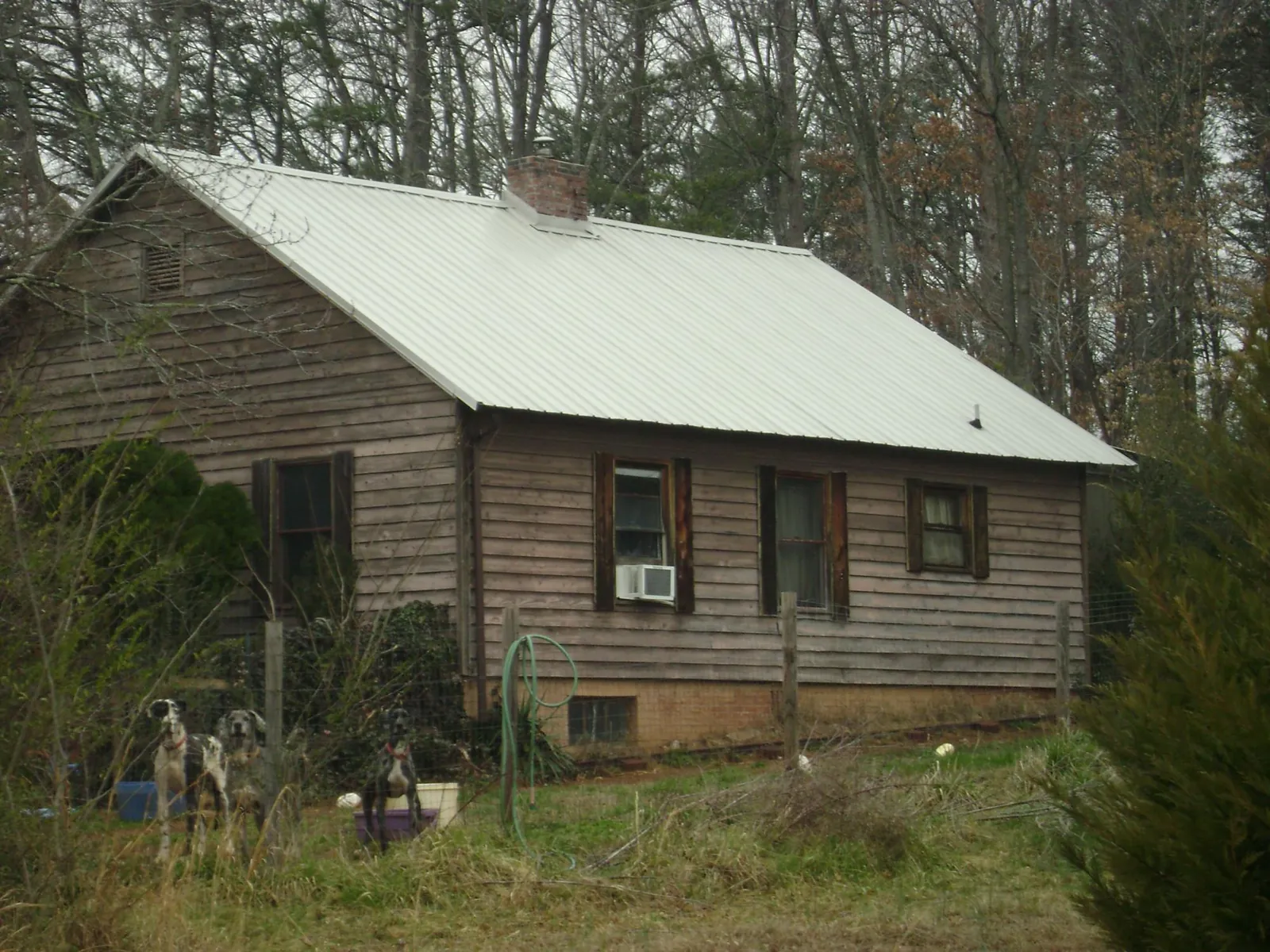 White metal roof on an old wood sided farmhouse, from a Metal Roof Installation job in Gibsonia